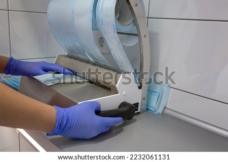 Automatic packaging of sterile instruments in the clinic or dentistry. Sterilization of instruments by a doctor's assistant, surgical instruments