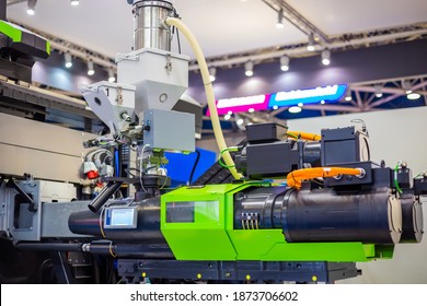 Automatic plastic injection molding machine during work at exhibition, trade show. Manufacturing, production, technology concept