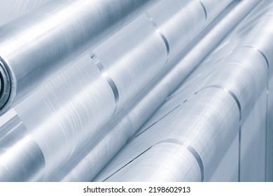 Automatic polyethylene plastic bag production machine with lighting effect. Close-up of the roller of the plastic bag production machine in the light blue scene. product packaging concept - Shutterstock ID 2198602913