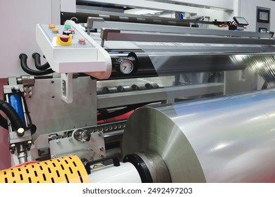 Automatic polyethylene plastic bag production machine with lighting effect. Close-up of the roller of the plastic bag production machine in the light blue scene. product packaging concept