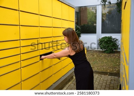 Automatic post office machine. Parcel storage room. Girl received a parcel. Yellow storage rooms