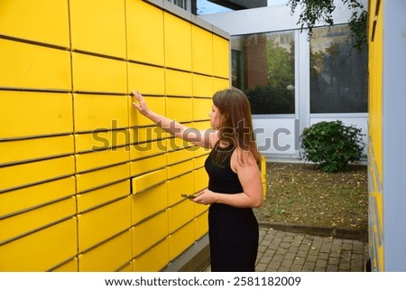 Automatic post office machine. Parcel storage room. Girl received a parcel. Yellow storage rooms