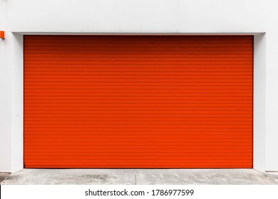 Automatic red roller shutter doors on the ground floor of the house