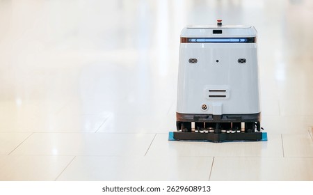 Automatic robot cleaner mopping of floor in commercial shop mall, industry machine with AI and camera.