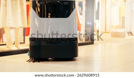 Automatic robot cleaner mopping of floor in commercial shop mall, industry machine with AI and camera.