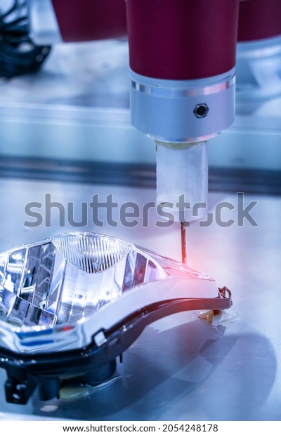 automatic robot drill machine\
tool at intelligence industrial manufacture headlight of a car\
factory