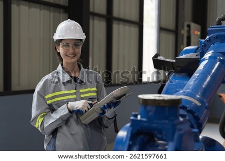Automatic robotic arm, Storage warehouse. Woman engineer control robotics arms. Installation, testing or setting robotics arms