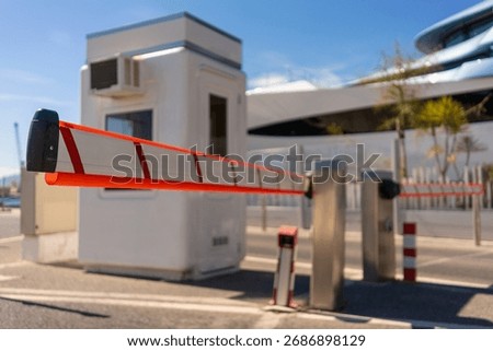 Automatic security barrier gate at parking entrance with small g