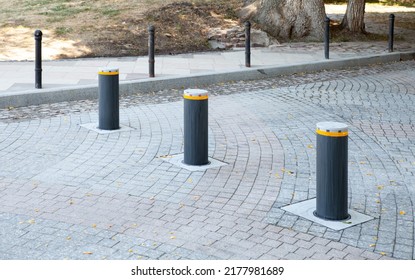 Automatic Security Bollards. Retractable Bollards With Warning Light. Lifting Metallic Bollard To Enable Or Block Traffic. Hydraulic Bollards To Protect Public And Private Property. Road Traffic Lock