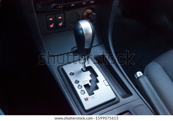 Automatic\
shift gear knob in the passenger compartment of the car in black\
for driving and acceleration. Abstract image of fast speed.\
Warranty and recall of transmission by\
dealer.