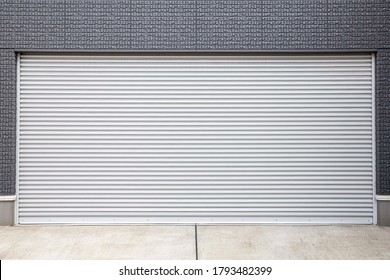 Automatic silver metal roller shutter doors on the ground floor of the house