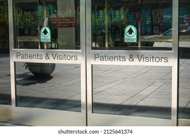 Automatic Sliding Glass Door Entrance To A Hospital That Says Patients And Visitors