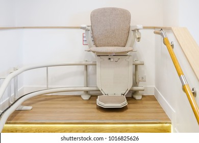 Automatic stair lift on staircase for elderly people and disabled persons - Shutterstock ID 1016825626