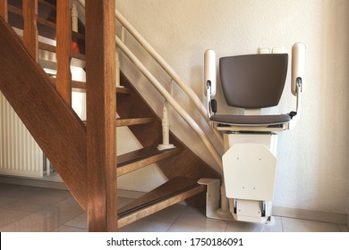 Automatic stairlift on staircase for elderly or disability in a house, taking people up and down