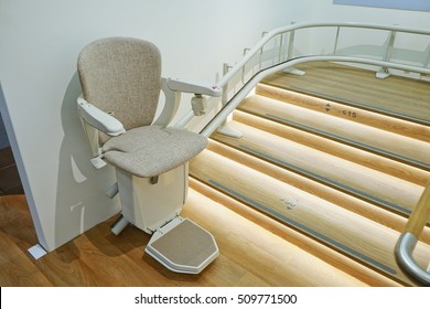Automatic stairlift on staircase for elderly or disability in a house, Health care concept.