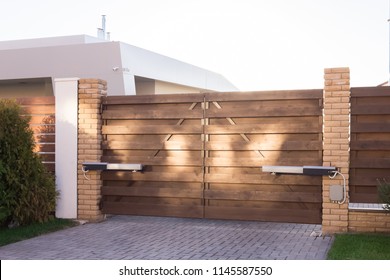 Automatic swing gates made of wood in a private house