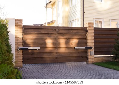 Automatic swing gates made of wood in a private house