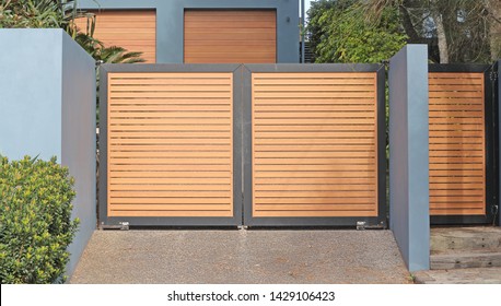 Automatic swing open front gates with horizontal wooden slats 