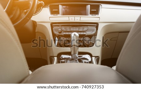 automatic transmission and center console in the light interior of the car