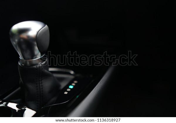 Automatic transmission gear on dark\
background.Modern new car interior,Close up of metallic silver\
Gearstick.Technology,Vehicle,Automobile\
Concept.