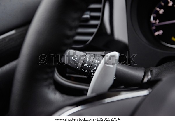 Automatic\
transmission lever in steering wheel in modern car. Close-up on\
interior details. Transmission\
shift.