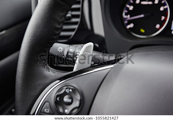 Automatic\
transmission lever in steering wheel in modern car. Close-up on\
interior details. Transmission\
shift.