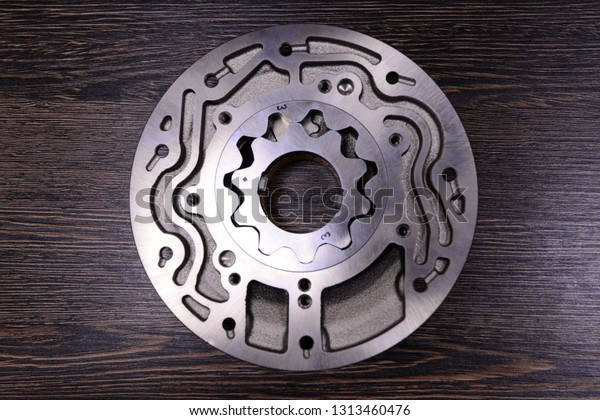 Automatic\
transmission oil pump on wooden\
background