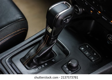 automatic transmission shift selector in the car interior. Closeup a manual shift of modern car gear shifter. 4x4 gear shift - Shutterstock ID 2137573781