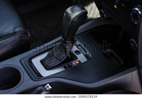 automatic transmission shift selector in the car\
interior. Closeup a manual shift of modern car gear shifter. 4x4\
gear shift