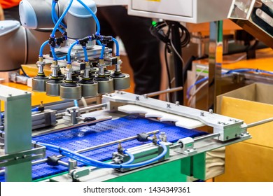 Automatic Vacuum Sucker Robotic Arm Holding Food Can In The Packaging Line 