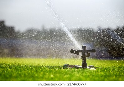 Automatic watering system sprays water on the lawn. Irrigation. - Shutterstock ID 2174405997