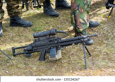 Automatic weapon standing on the ground during a briefing of special forces