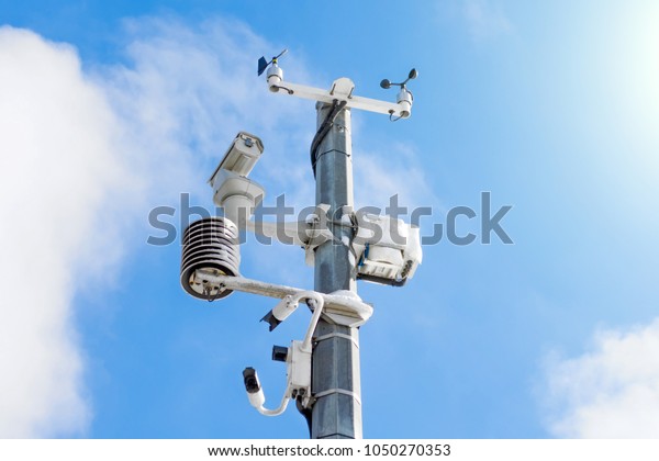 Automatic weather station, with a weather\
monitoring system and video cameras for observation. Against the\
background of a blue sky with\
clouds.