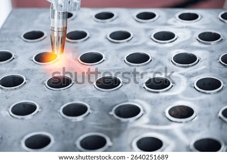 Automatic welding process on heat exchange pipes in industrial setting.