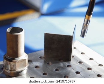 Automatic welding process on welding table closeup
