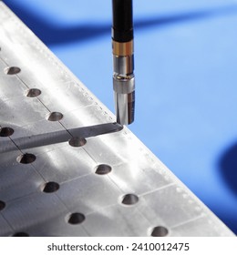 Automatic welding torch on welding table closeup