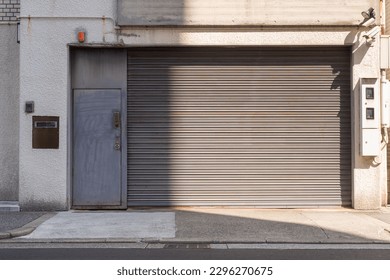 Automatic white roller shutter doors on the ground floor of the house