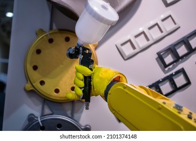 Automatic Yellow Spray Painting Robotic Arm Manipulator Demonstrates Functionality At Smart Robot Technology Exhibition, Trade Show. Manufacturing, Futuristic, Production Concept