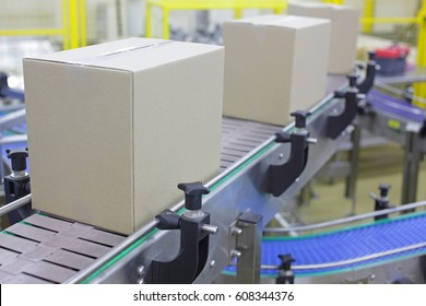 Automation - Cardboard boxes on conveyor belt in factory - Powered by Shutterstock