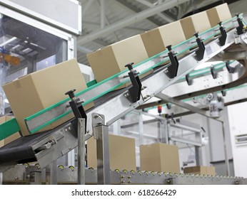 Automation - Cardboard boxes on conveyor belt in factory - Powered by Shutterstock