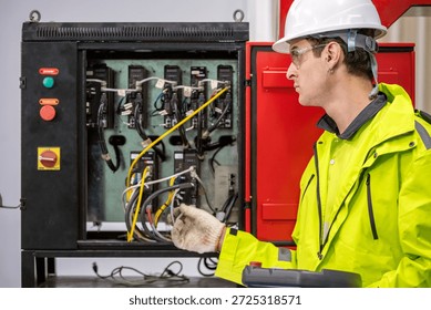Automation Engineer Inspecting Control Panel in Industrial Factory Male Engineer Checking Electrical Wiring and Robot Control System Engineer with Hard Hat and Gloves Working on Control Panel