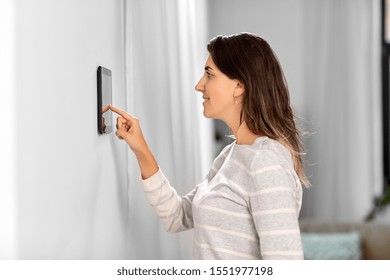 automation, internet of things and technology concept - woman using tablet pc computer at smart home - Shutterstock ID 1551977198