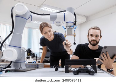 automation machine engineer students study and inspection control robot arm machine in robotics engineering academy at university or factory workshop. AI robot technology, future innovation trend. - Powered by Shutterstock