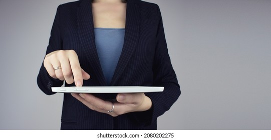 Automation Software Technology Process System Business concept. White tablet in businesswoman hand with digital hologram icon sign on grey background