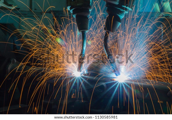  Automation welding mechanical\
procedure.,Industrial Robot arm active in\
factory