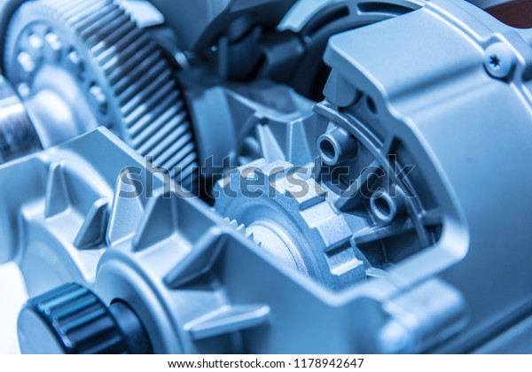 Automobile car gearbox with toothed wheels. Inside\
view on gearbox cross section with gears and shafts. Car gearbox\
with open hood\
cover.