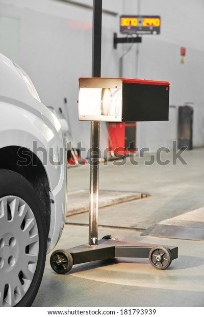 automobile car inspection headlight checkup at\
repair service\
station