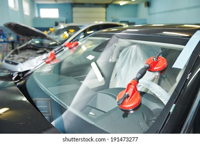 Automobile car windshield or windscreen service concept in auto service station garage
