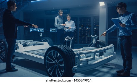 Automobile Design Engineers Working on Electric Car Platform Chassis Prototype, Using CAD Software for 3D Concept. In Automotive Innovation Facility Vehicle Frame with Tires, Suspension, Engine - Shutterstock ID 1455249914