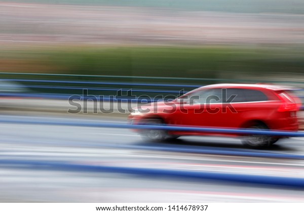 Automobile driving fast in\
an urban road